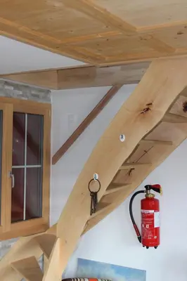 a wooden ceiling with a fire extinguisher under it at Chalet Nueschwendi in Ebnat