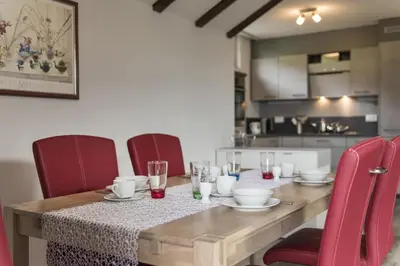 a dining room table with red chairs and a tableablish at Bella Vista in Wildhaus
