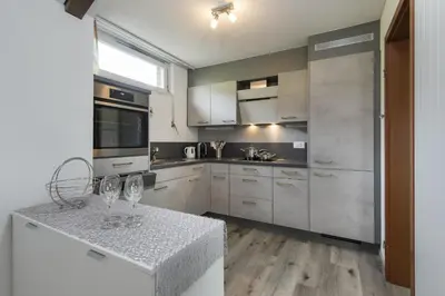 a kitchen with a counter with two wine glasses on it at Bella Vista in Wildhaus