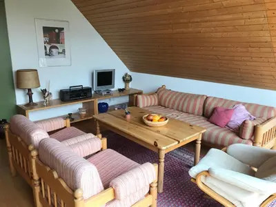 a living room with two couches and a table at Jizerka in Unterwasser
