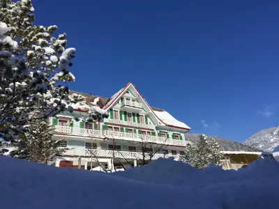 a large building with snow on the ground at Gasthaus Friedegg in Wildhaus