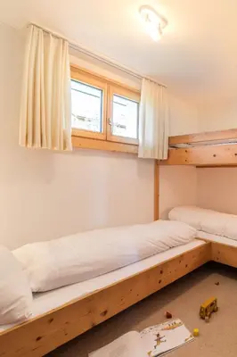 two bunk beds in a room with a window at Steinrüti in Wildhaus