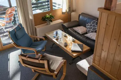 a living room with a couch and a table at Chalet Pfiff in Wildhaus