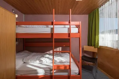 a bunk bed room with two bunk beds in it at Chalet Pfiff in Wildhaus