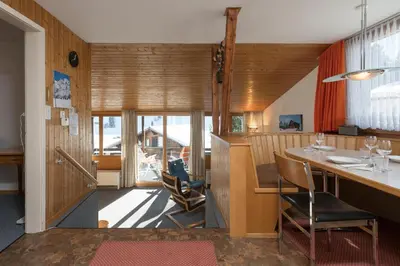 a kitchen with a table and chairs in a room at Chalet Pfiff in Wildhaus