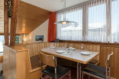 a dining room with a table and chairs at Chalet Pfiff in Wildhaus