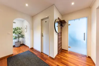 an empty hallway with a door and a mirror at Schwalbennest in Wildhaus