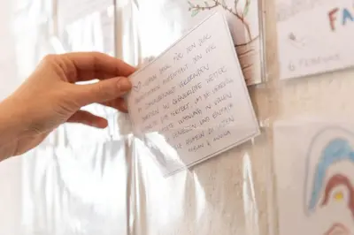 a person holding a piece of paper with a note at Schwalbennest in Wildhaus