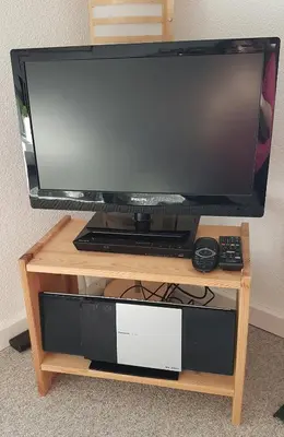 a flat screen tv on a wooden tv stand at Family Mountain View - Upper Alley in Buchs