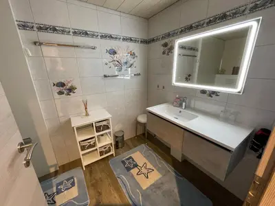 a bathroom with a sink and a mirror at Hälmli in Heiden