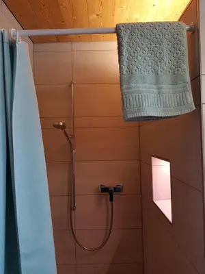 a bathroom with a shower with a shower curtain at Ferien im Gugger in Nesslau