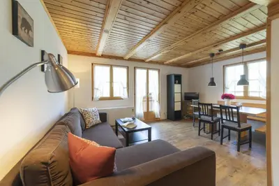 a living room with a couch and a table at Schönau in Wildhaus