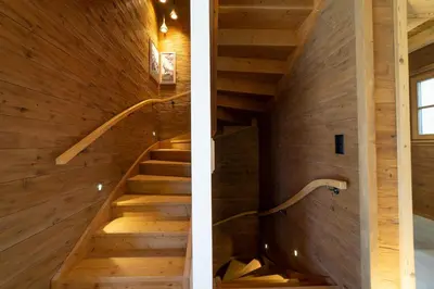 a staircase in a house with wooden walls at Chalet Hinterrugg in Wildhaus