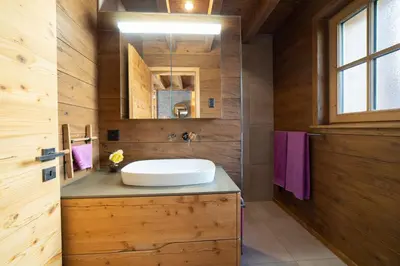 a bathroom with a sink and a mirror at Chalet Hinterrugg in Wildhaus