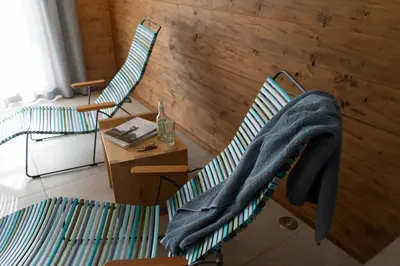 a room with two chairs and a table with a sweater on them at Chalet Gamserrugg in Wildhaus