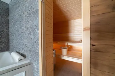 a small bathroom with a sauna with wooden walls at Chalet Gamserrugg in Wildhaus