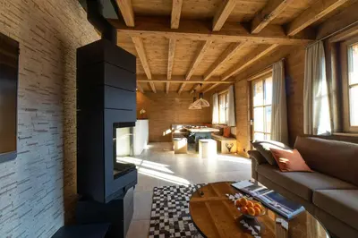 a living room with a couch and a fireplace at Chalet Chäserrugg in Wildhaus