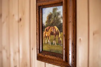a framed painting of two horses in a field at Hof-Tschannen in Lengwil