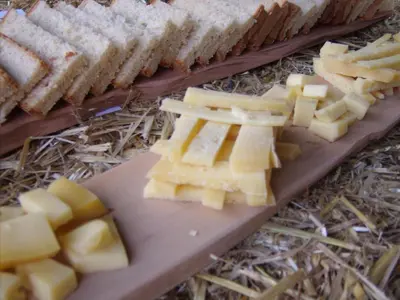a cutting board with cheese and sandwiches on it at Steigmatt Bauernhof- Erlebnis in Montlingen