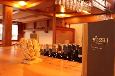 a display of wine bottles on a table in a room at Hotel Restaurant Rössli in Alt Sankt Johann