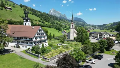 an aerial view of a village with a church at Hotel Restaurant Rössli in Alt Sankt Johann