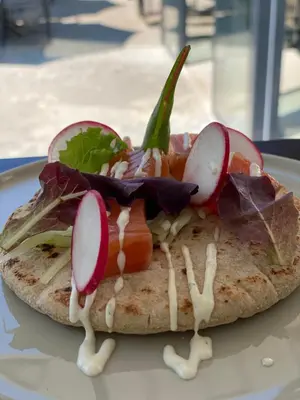 a sandwich with vegetables on a white plate at Hotel Restaurant Rössli in Alt Sankt Johann