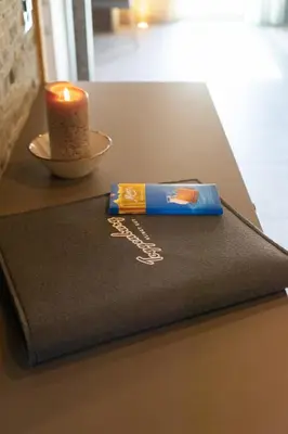 a candle on a table with a black napkin at Chalet Zuestoll in Wildhaus