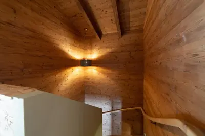 a room with wooden walls and a light on the ceiling at Chalet Schafberg in Wildhaus