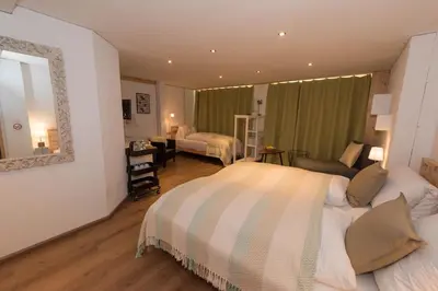 a hotel room with a bed and a mirror at BnB Alpenblick in Lütisburg