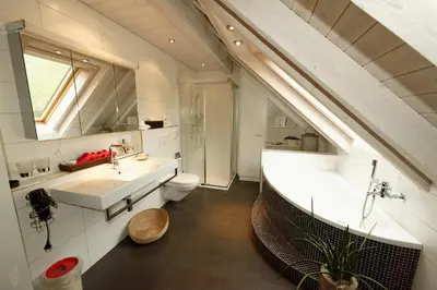 a bathroom with a tub and a toilet and a sink at BnB Alpenblick in Lütisburg