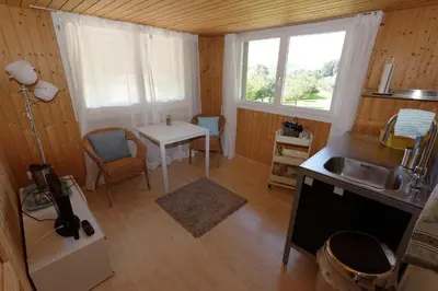 a small kitchen with a sink and a table at BnB Alpenblick in Lütisburg