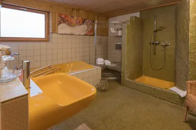 a bathroom with a sink and a tub and a shower at BnB Alpenblick in Lütisburg