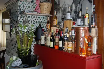 a bar with a bunch of bottles on a shelf at Hotel Restaurant Pizzeria Rotes Haus in Landschlacht Gemeinde Münsterlingen