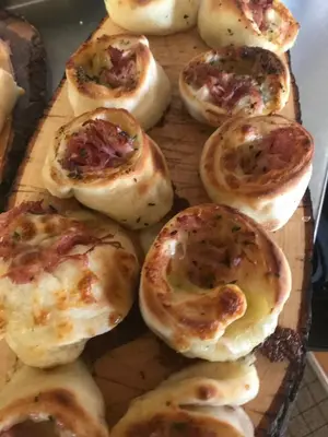 a pile of biscuit pies on a cutting board at Hotel Restaurant Pizzeria Rotes Haus in Landschlacht Gemeinde Münsterlingen