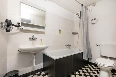 a white bathroom with a sink and a toilet at SOHO F !Gratis Parken, Free Parking! in Kreuzlingen