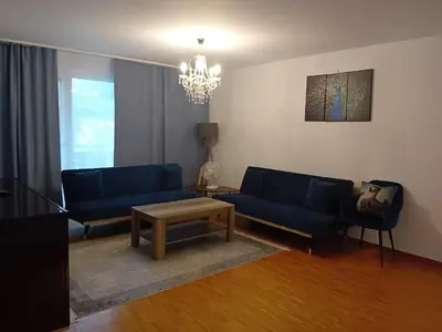 a living room with two blue couches and a table at 3 Room Premium Apartment Buchs SG in Buchs