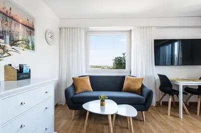 a living room with a blue couch and a table at SOHO 5B !Gratis Parken, Free Parking! in Kreuzlingen
