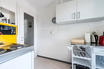 a kitchen with white cabinets and a stove top oven at SOHO 5B !Gratis Parken, Free Parking! in Kreuzlingen