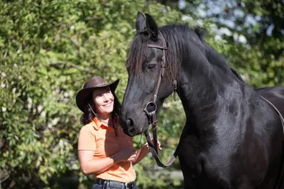 a woman standing next to a black horse at BnB Haag in Haag
