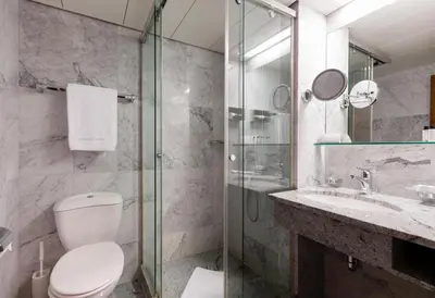 a bathroom with a toilet and a sink and a shower at Einstein St. Gallen in St. Gallen