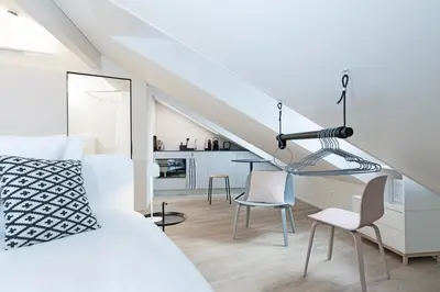 a bedroom with a bed and a dining room at Dom Studios in St. Gallen