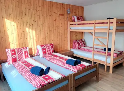 a room with two bunk beds and a ladder at Galluszentrum in Wildhaus