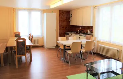 a kitchen and dining room with a table and chairs at Galluszentrum in Wildhaus