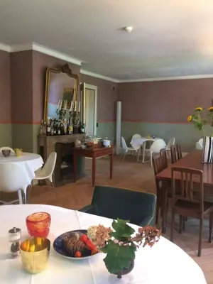 a dining room with a table with a plate of food at Schloss Brunnegg in Kreuzlingen