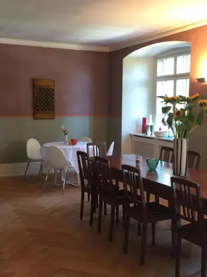 a dining room with a table and chairs at Schloss Brunnegg in Kreuzlingen