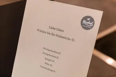a white menu for the kinks music cafe at Neuhof Gäste-& Schokohaus in Appenzell