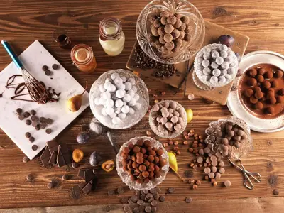 a wooden table topped with different types of chocolate at Neuhof Gäste-& Schokohaus in Appenzell