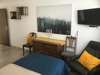 a bedroom with a desk and a tv and a chair at Sonnastuba in Wildhaus