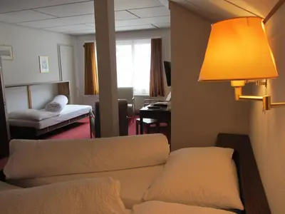 a living room with a couch and a lamp at Landhaus an der Thur in Alt Sankt Johann