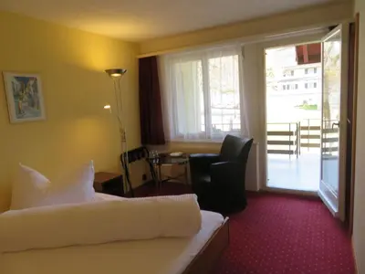 a hotel room with a bed and a desk and a window at Landhaus an der Thur in Alt Sankt Johann